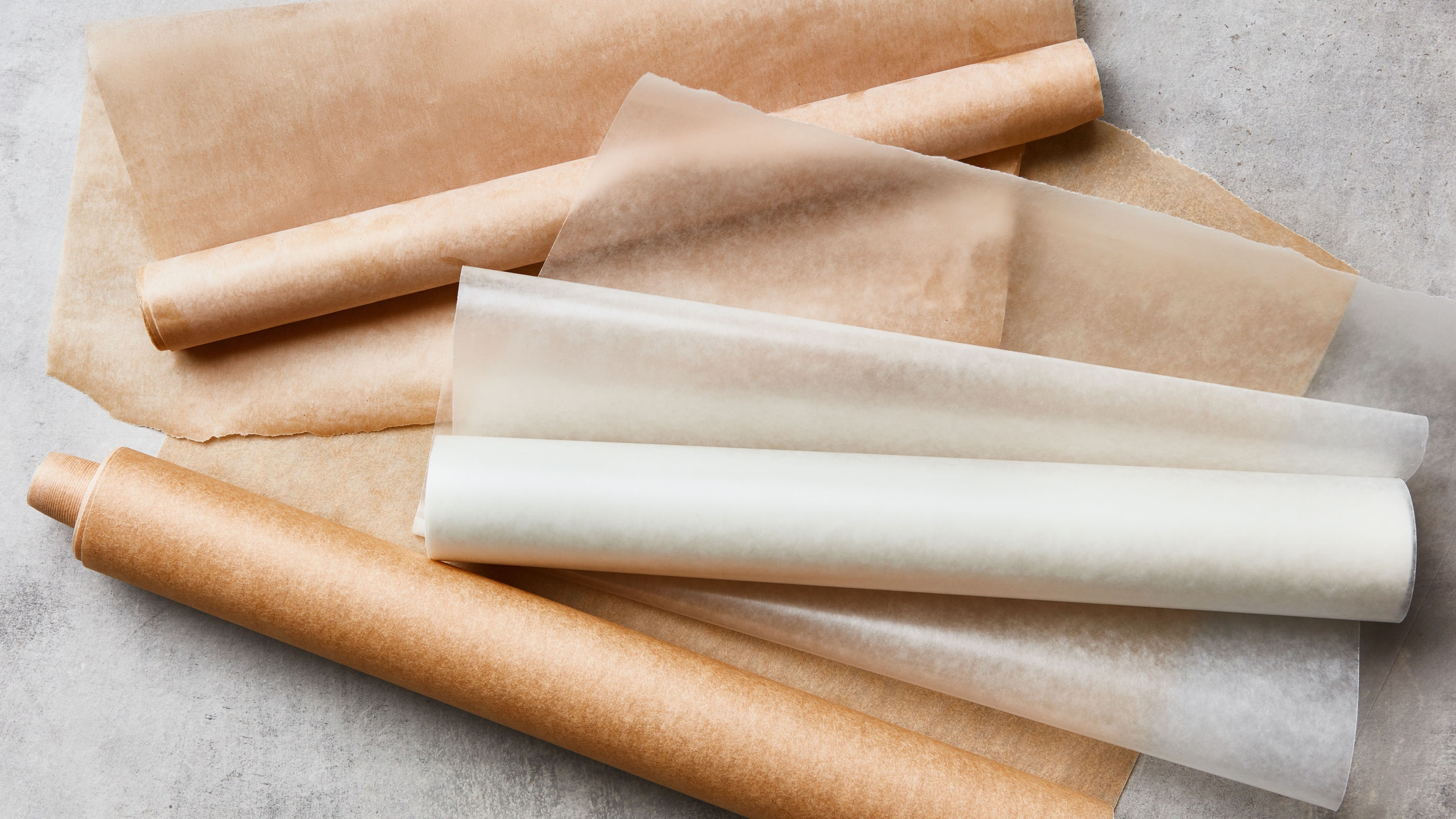 Two rolls of parchment paper and a roll of wax paper.