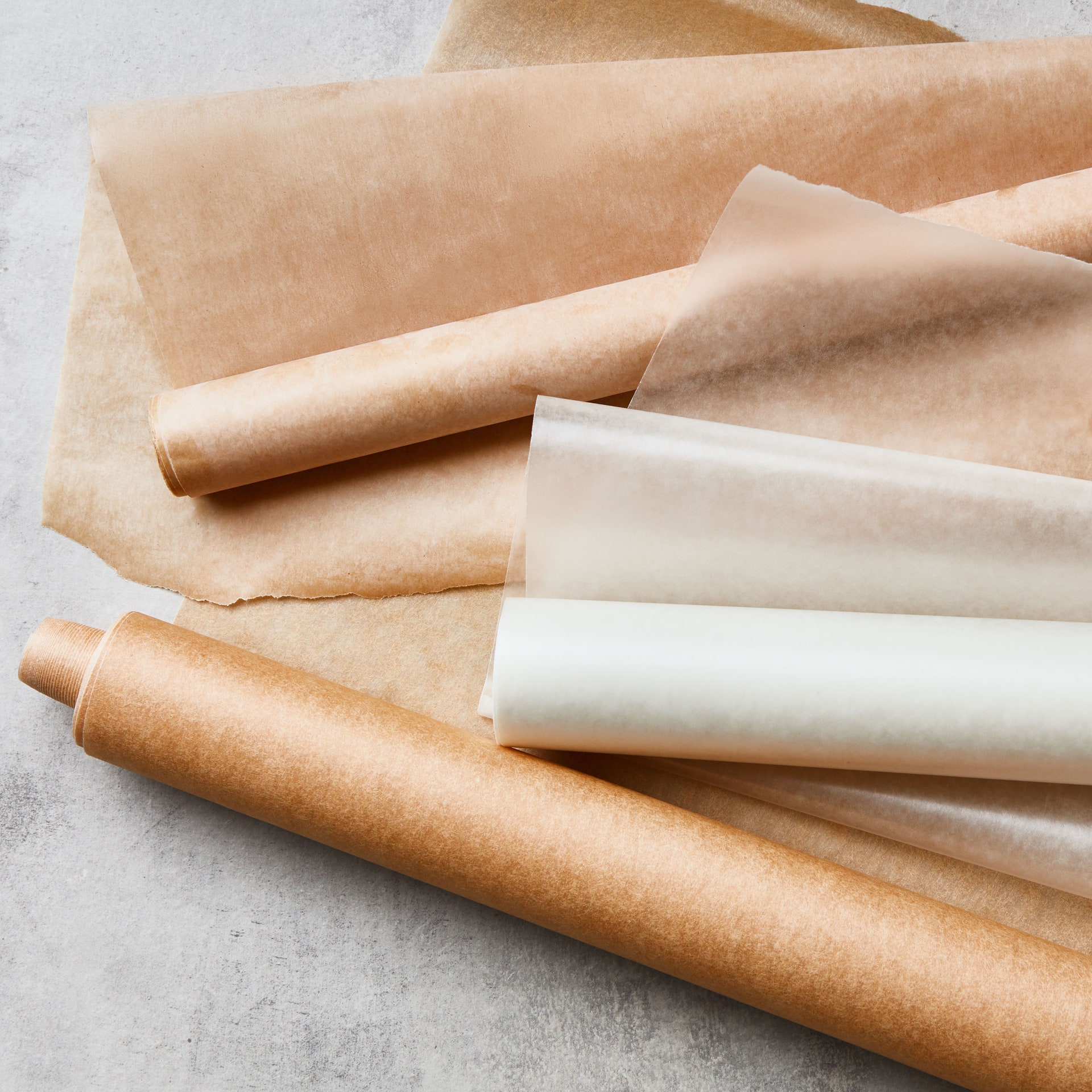 Two rolls of parchment paper and a roll of wax paper.